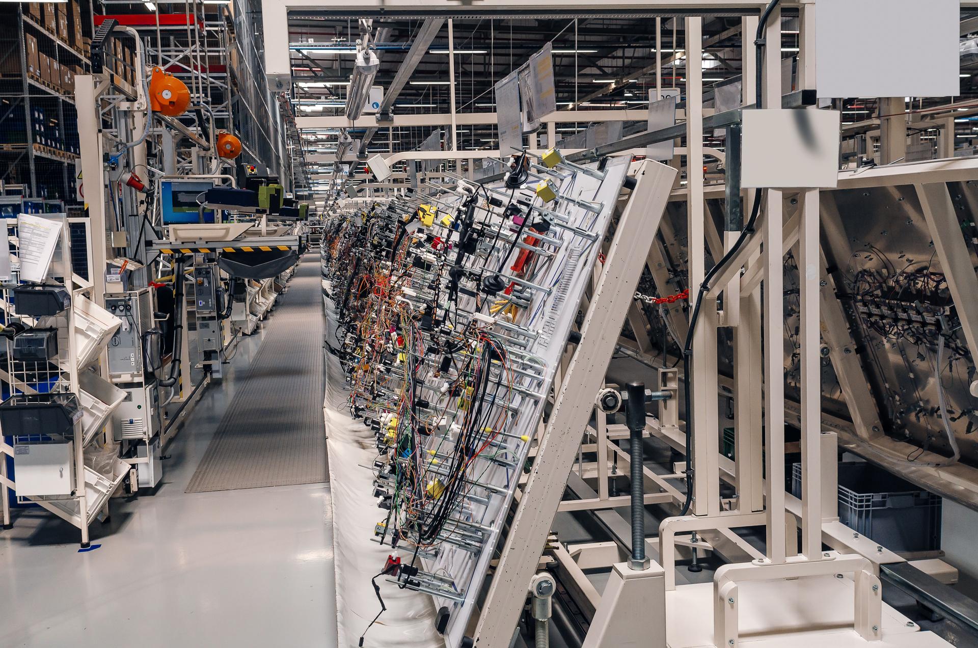 Production room with stands for the manufacture of wiring for cars in a modern factory.