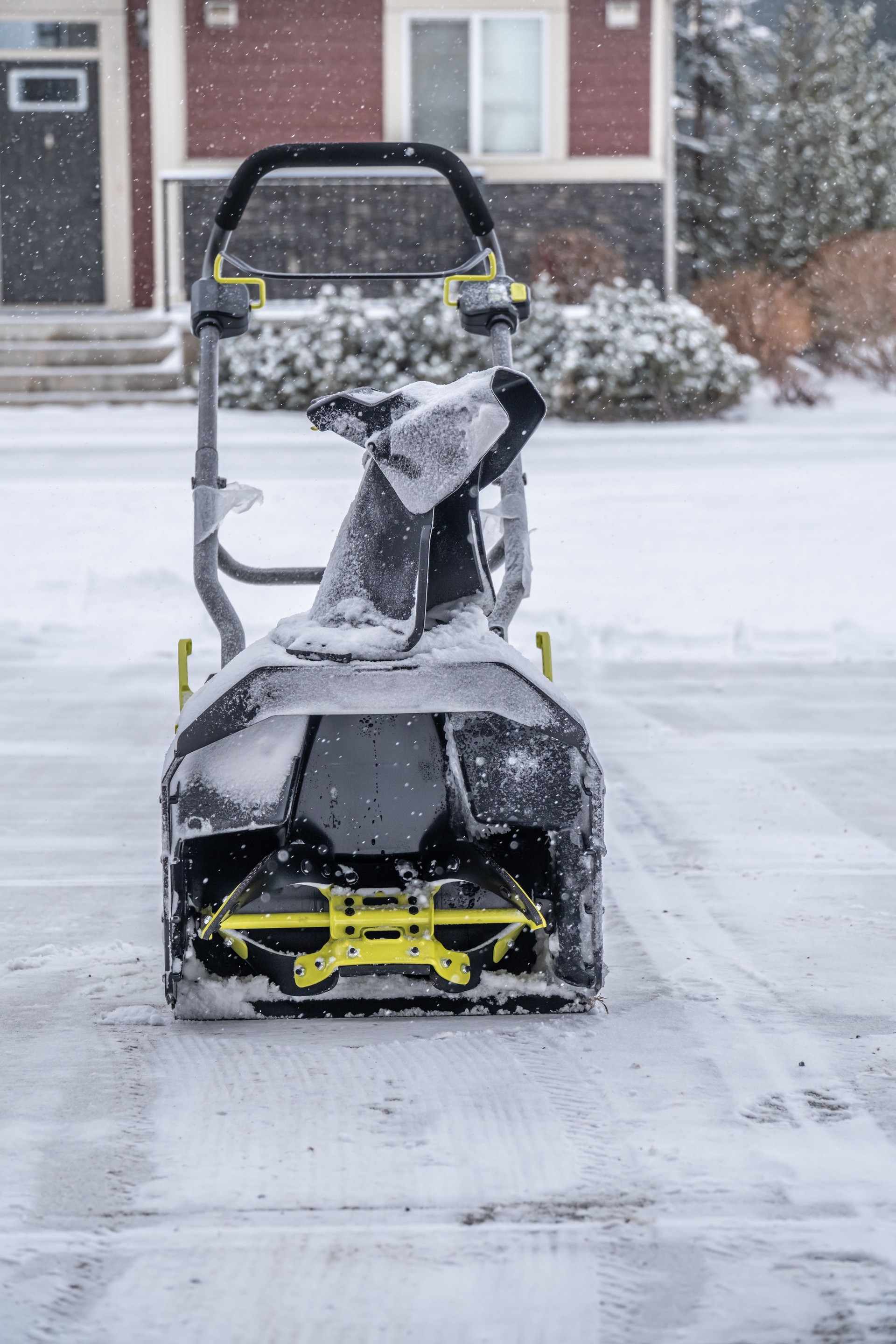 Cordless electric Snowblower on Driveway to clear snow in winter