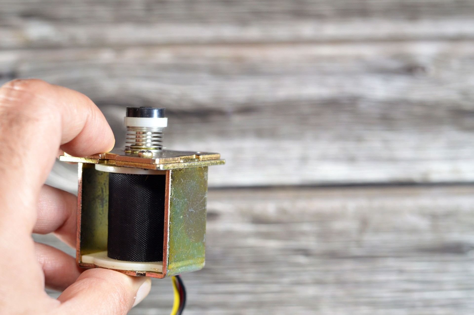 Gas geyser coil solenoid valve of gas water heater, maintenance and repairing home appliances concept, a solenoid valve is an electromechanically operated valve